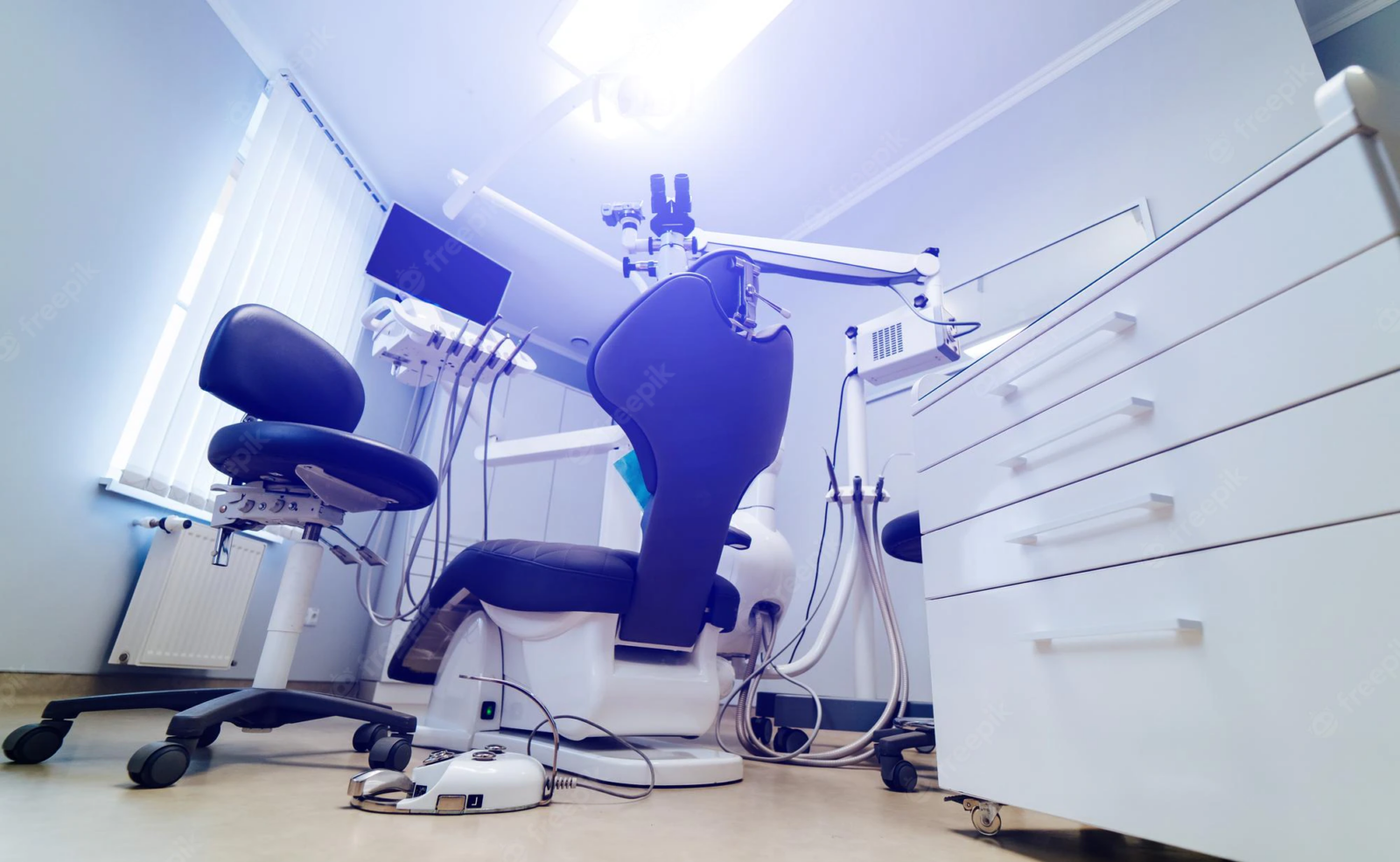 modern dental patient rig including chair, lights, microscope, and computer